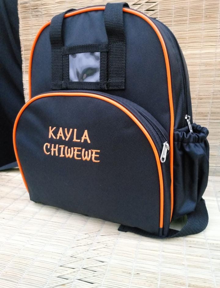 Navy backpack with orange trim and Kayla Chiwele name